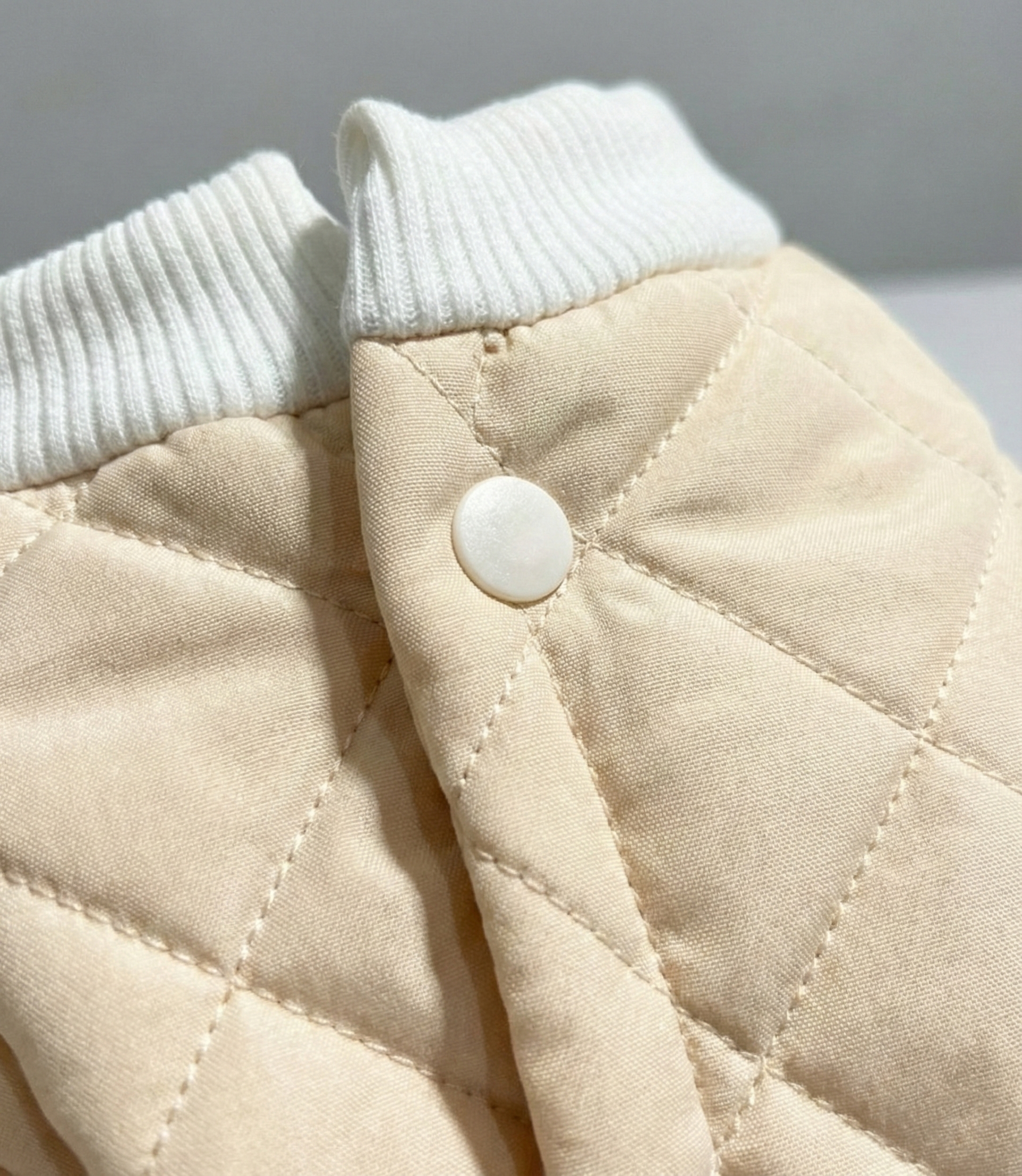 Köpek kıyafeti detaylı kumaş dokusu, ribana yaka ve çıtçıt düğme yakından görünüm.